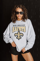 NEW ORLEANS SAINTS FIGHTING SPIRIT RELAXED FIT HEATHERED LONG SLEEVE FRENCH TERRY PULLOVER