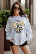 NEW ORLEANS SAINTS FIGHTING SPIRIT RELAXED FIT HEATHERED LONG SLEEVE FRENCH TERRY PULLOVER