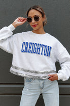 CREIGHTON BLUEJAYS PASS THE SHINE LONG SLEEVE METALLIC SHIMMER-STRIPE TOP WITH RIBBED NECKLINE AND CUFFS