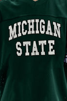 MICHIGAN STATE SPARTANS UNTIL KICKOFF OVERSIZED V-NECK RHINESTONE-STRIPED TRIM FASHION JERSEY