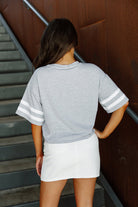 LOS ANGELES CHARGERS GRIDIRON GLAM SHORT SLEEVE CROP TEE WITH SPORT STRIPE DETAIL