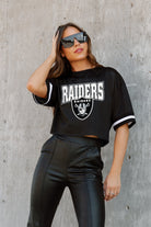 LAS VEGAS RAIDERS AUTOMATIC DOWN LIGHTWEIGHT SPORTY TOP WITH STRIPED SLEEVE DETAIL