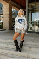 TENNESSEE TITANS SIDELINE HOODED LEOPARD FLEECE PULLOVER WITH FRONT POCKET AND SIDE-SLIT DETAIL